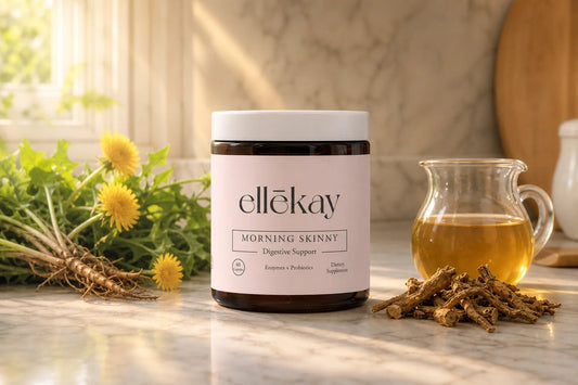 Ellekay supplement jar on a marble counter surrounded by fresh dandelion plants and dried dandelion root for digestion support