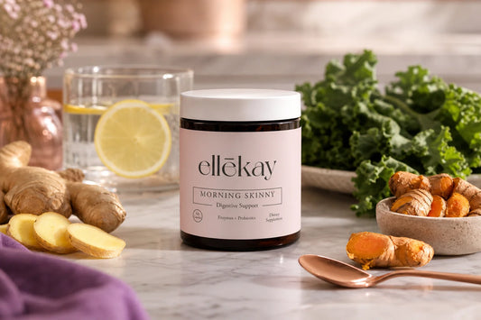 Ellekay supplement bottle on marble counter with fresh ginger and turmeric, representing gut health and joint pain support through daily wellness