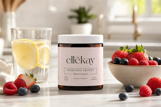 A bright, airy morning kitchen counter with a glass of water, fresh lemon slices, and a small bowl of berries bathed in soft natural sunlight, feminine wellness aesthetic