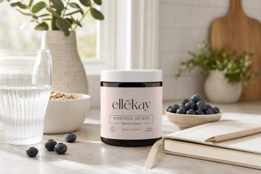 Bright morning kitchen counter with a clear glass of water, fresh oats, blueberries, and an open wellness journal in warm golden light, representing postbiotics explained and gut health