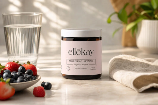 Sunlit kitchen counter with water, berries, and a linen napkin representing a morning gut health routine with probiotic strains for bloating