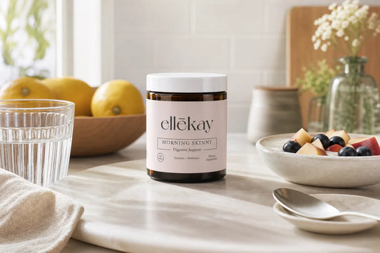 Bright morning kitchen with a glass of water and fresh citrus on a white marble counter, strongest digestive enzymes wellness lifestyle