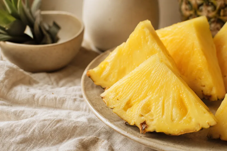 Fresh pineapple wedges in close-up, the fruit source of the enzyme bromelain